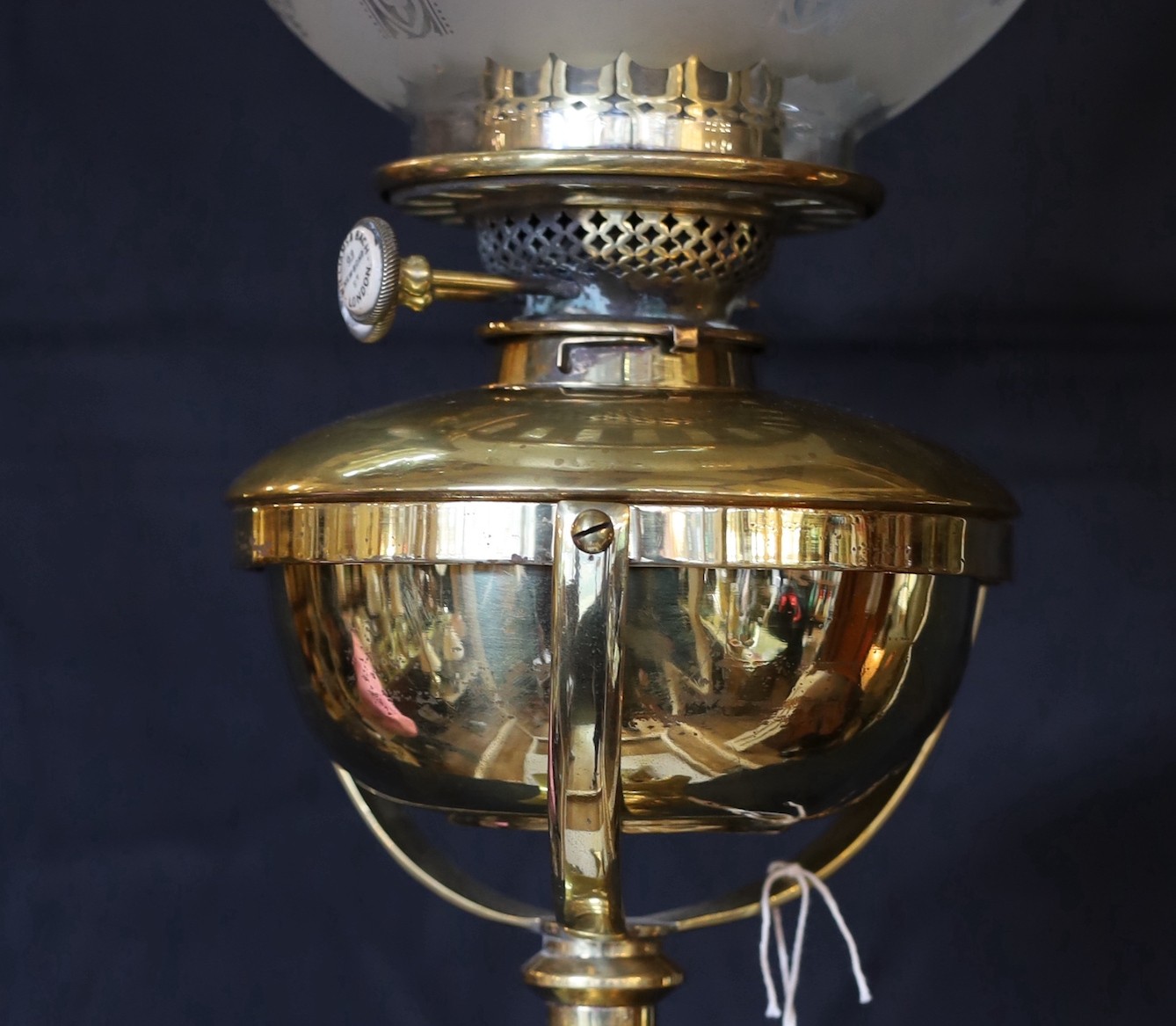 A Victorian brass Regency style print Corinthian telescopic oil lamp standard, with later etched glass globe and Williams & Bach of 92 New Bond Street London mechanism, height 170cm. width of base 34cm.